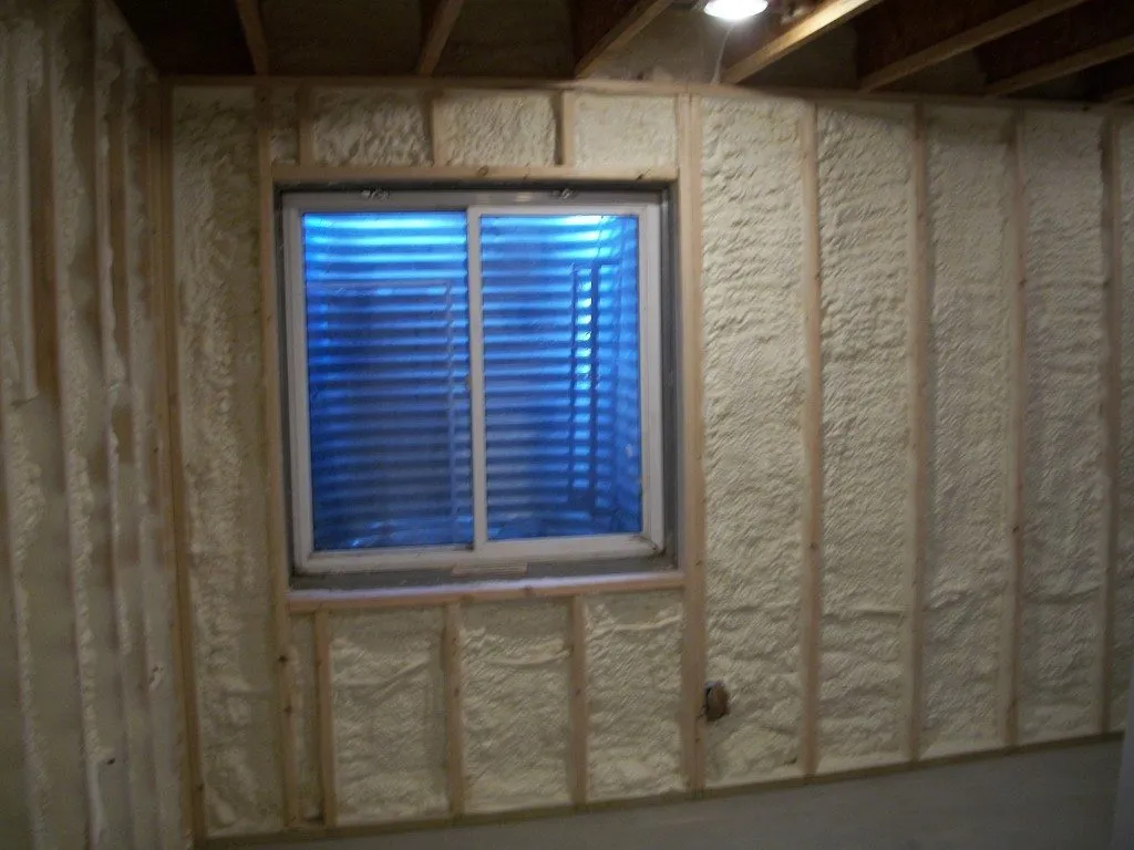Basement wall insulation with foam around window