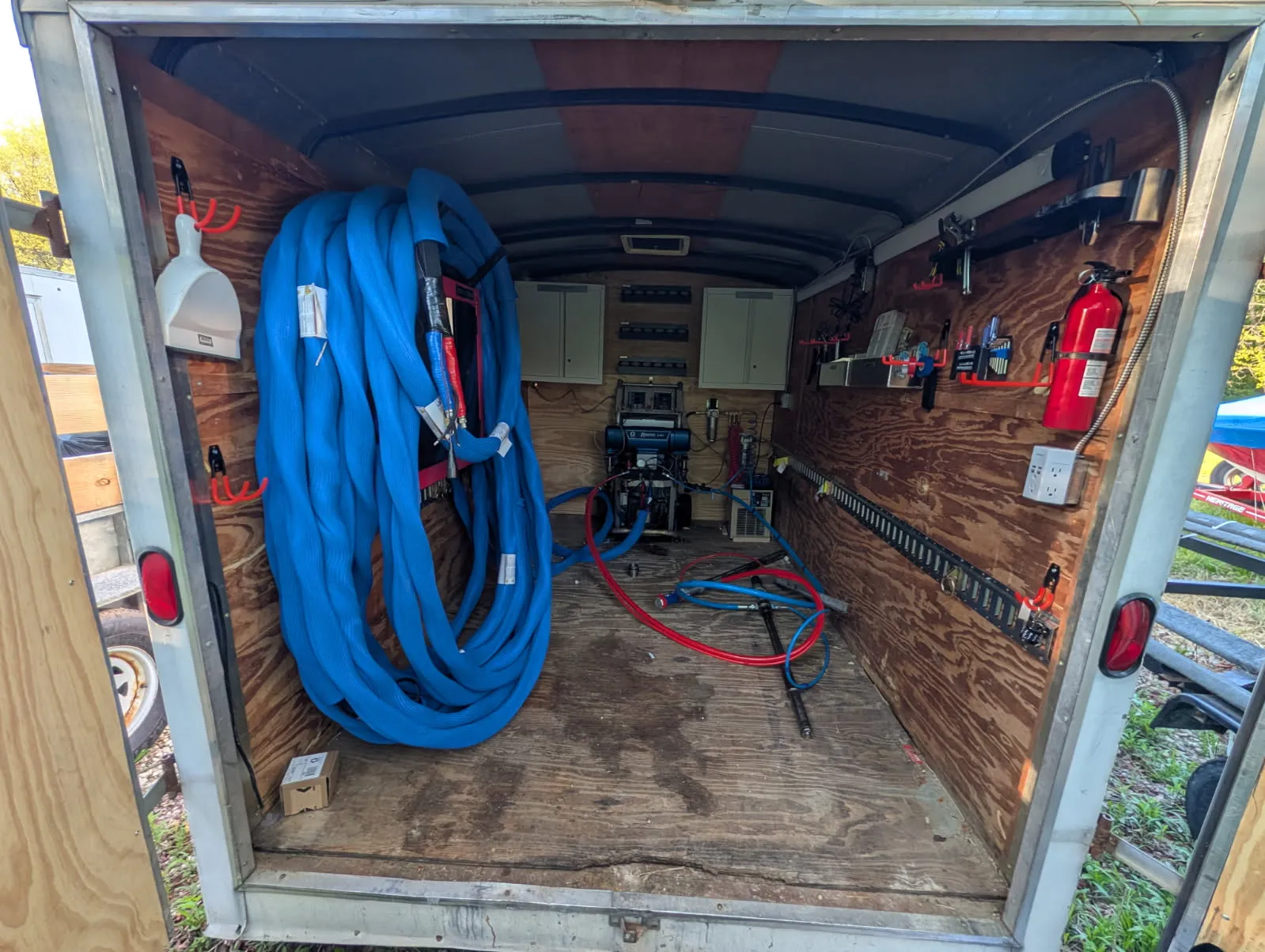 Spray foam rig rental Indiana equipment trailer with hoses and supplies