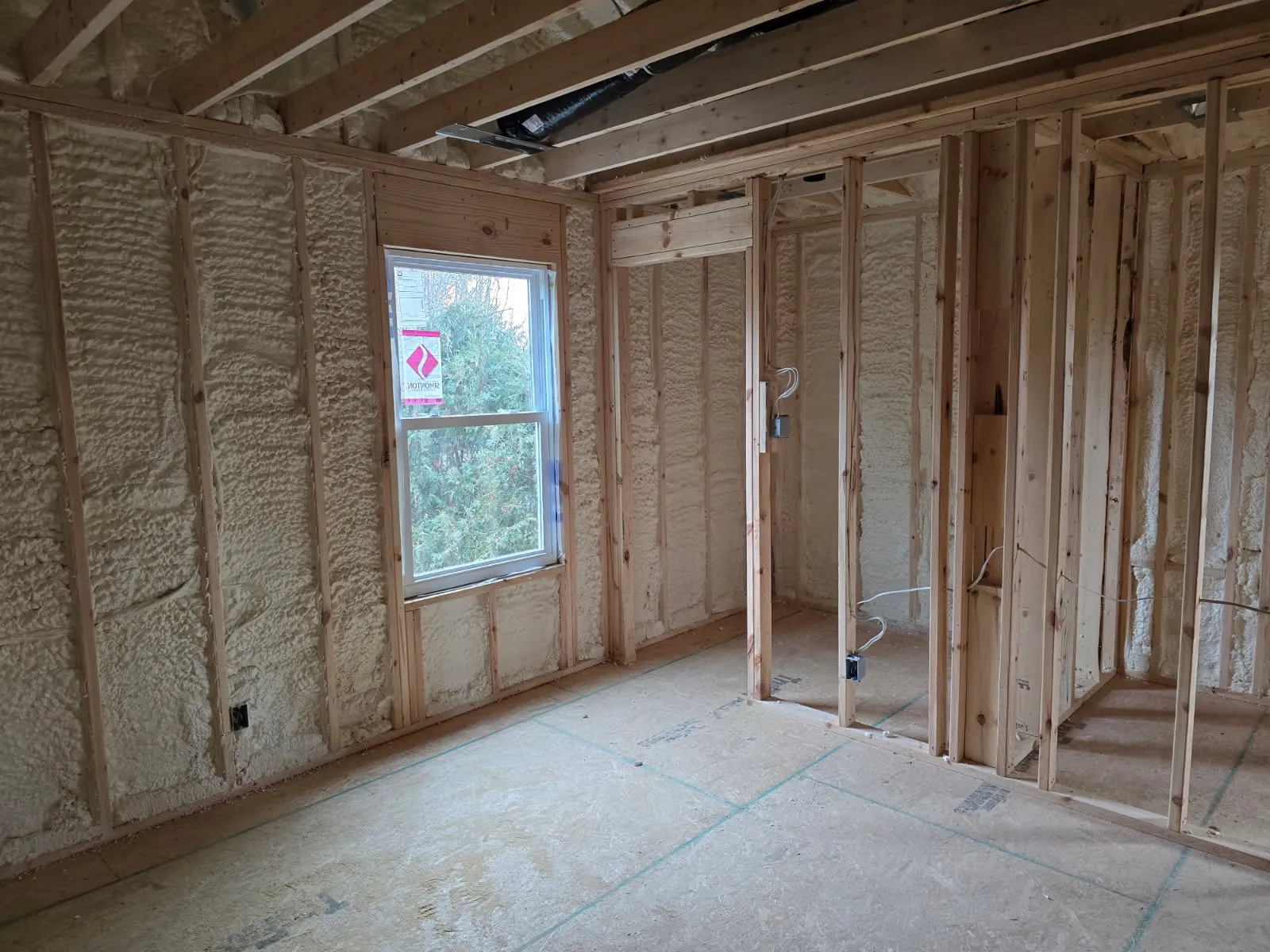 New construction room with open-cell spray foam in walls and ceiling