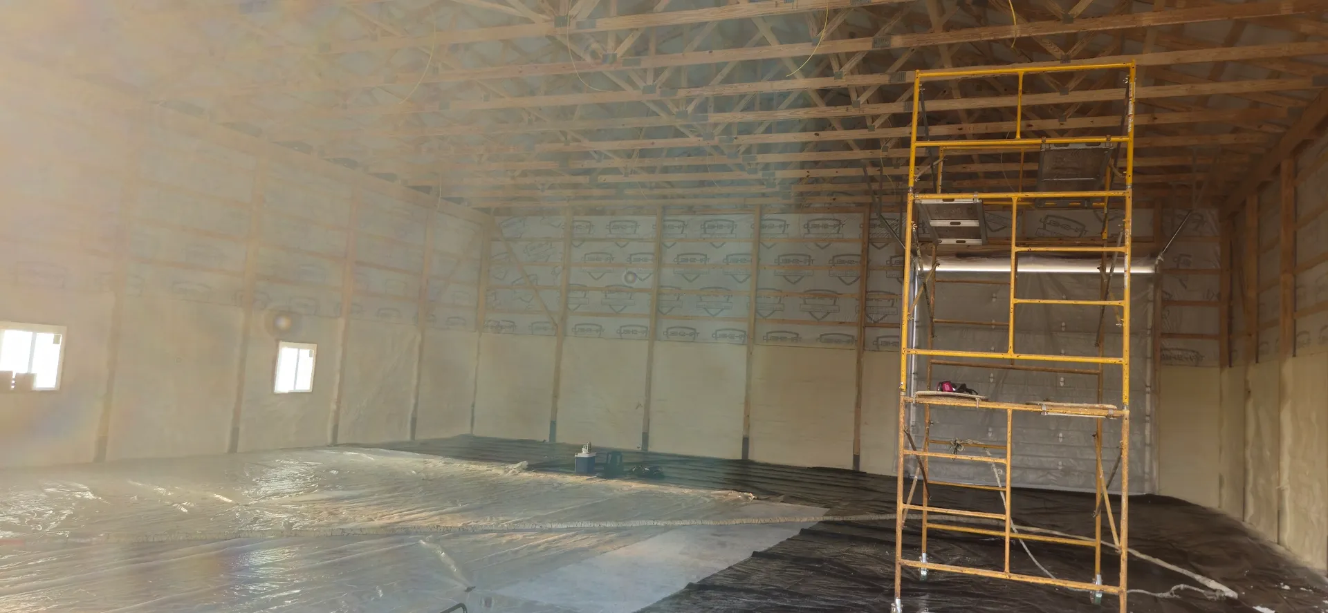 Wide angle of pole barn with scaffolding